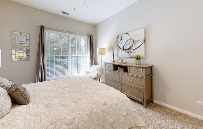 a bedroom with a large bed and a window