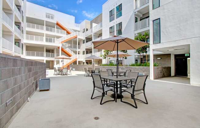 a patio with a table and chairs and an umbrella