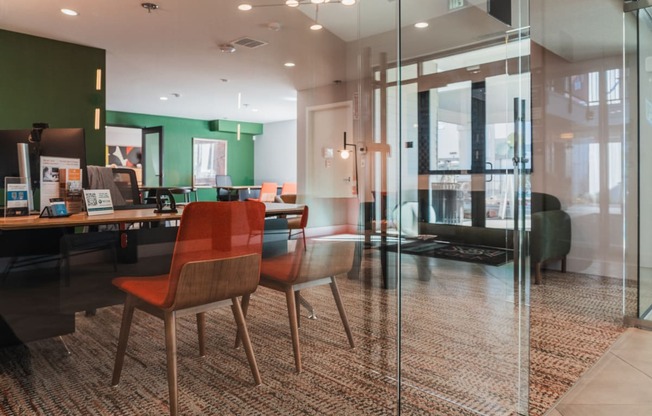 a conference room with glass walls and a table with chairs