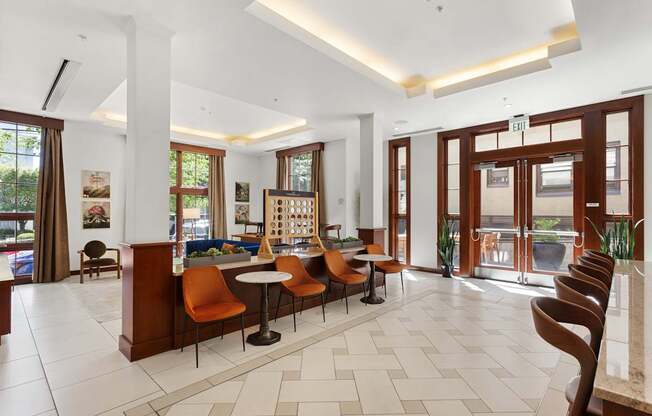 the lobby of a hotel with a reception desk and chairs