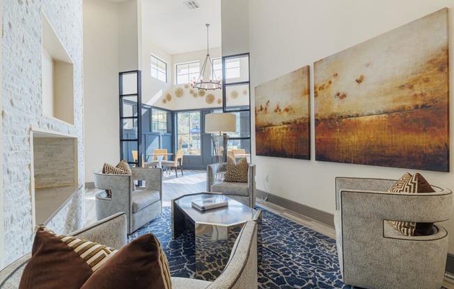 a living room with couches and chairs and a fireplace