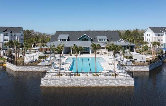 Lake Nona Concorde's pool, sundeck, and clubhouse beside the pond