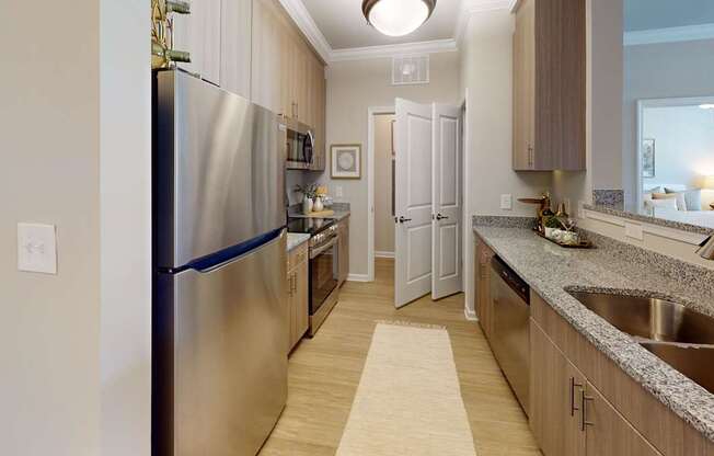 a designer kitchen with granite countertops and stainless steel appliances