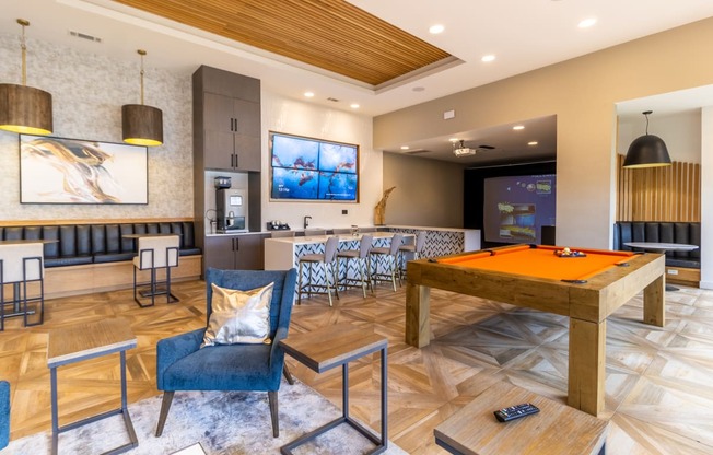 a games room with a pool table and bar
