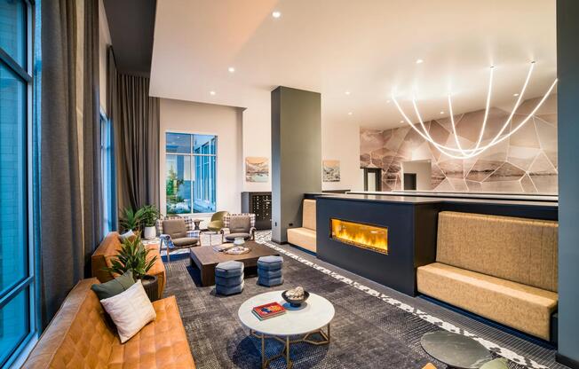 Warm tones and modern finishes create an inviting lounge at Modera Shoreline—perfect for connecting with neighbors or relaxing fireside.
