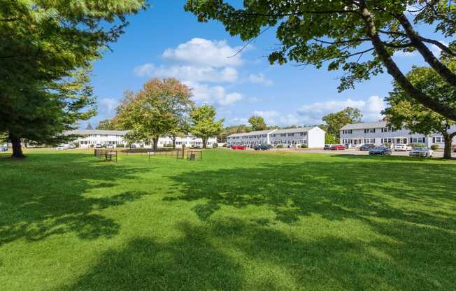 a park with green grass and the apartment buildings in the backgroundat Fox Hill Commons, Vernon, CT, 06066