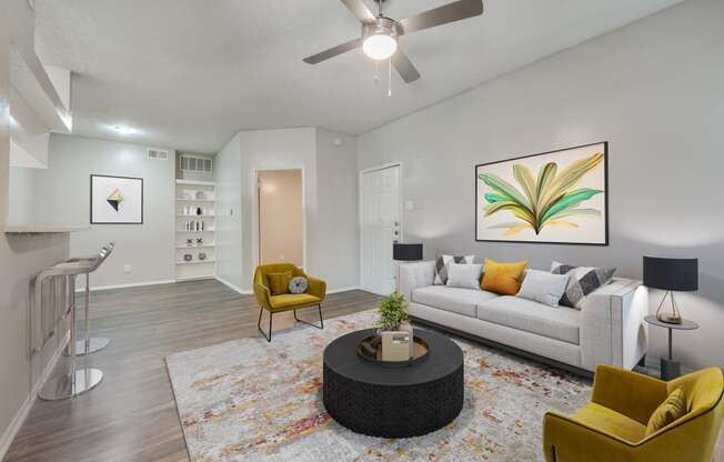 a living room with a couch and a ceiling fan