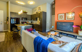 Harmony Luxury Apartments entertainment room with hardwood floors