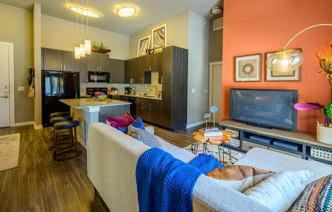 Harmony Luxury Apartments entertainment room with hardwood floors