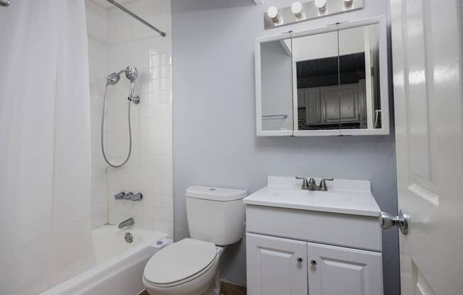 A white toilet and sink in a bathroom.