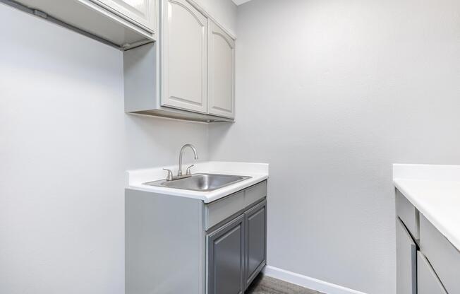 a kitchen with a sink and a mirror