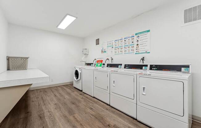 A laundry room with a washer and dryer on the wall and a basket on the counter.