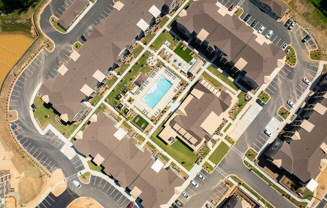 an aerial view of a neighborhood with houses and a pool