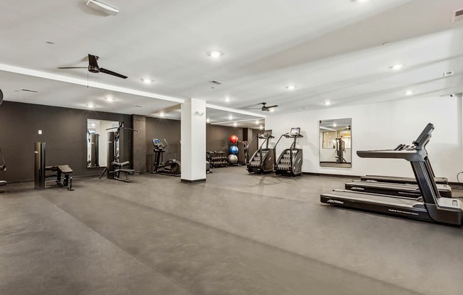 A spacious gym with various exercise equipment.