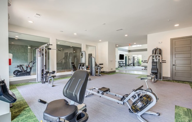 a home gym with exercise equipment and a bathtub at Century University City, Charlotte, North Carolina