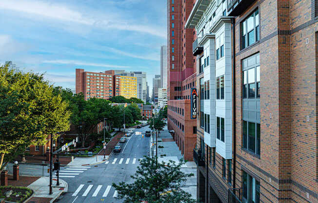 A city street with buildings on both sides and a crosswalk in the middle.