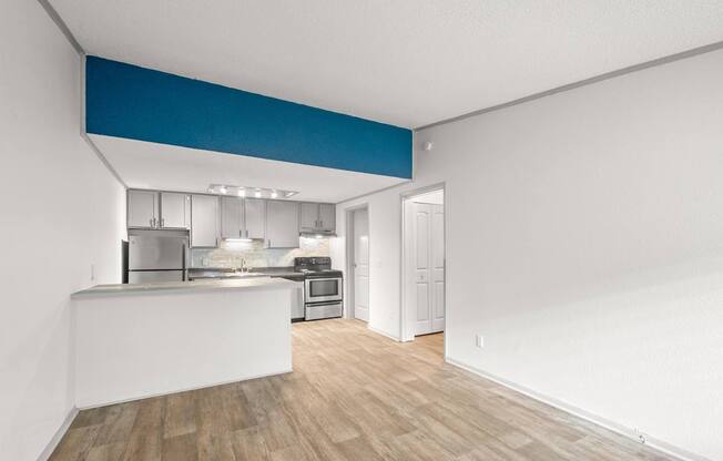 Retreat at Indian Lake Hendersonville TN apartments kitchen with white countertops and a blue stripe on the wall.