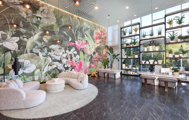 A living room with a large floral mural on the wall and a variety of plants on shelves.