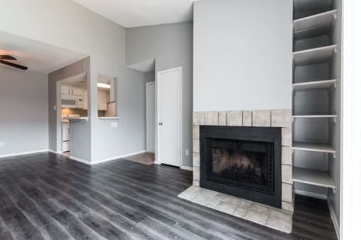 a living room with a fireplace and a book shelf