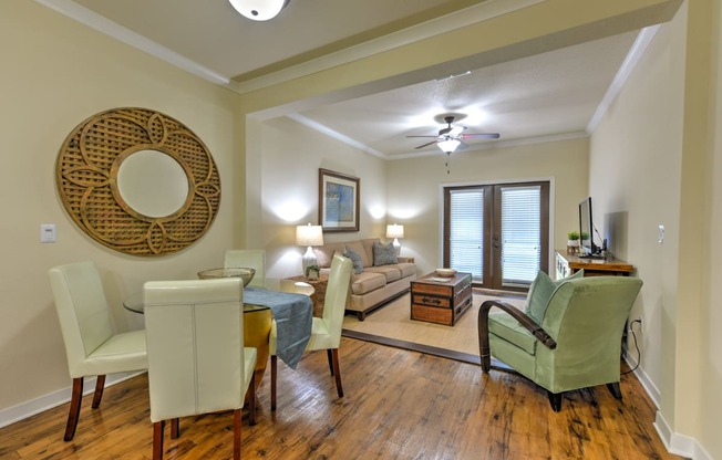 a living room and dining room with a couch and a table at Hacienda Club, Jacksonville, FL, 32256