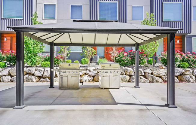 a covered barbecue area with two bbq grills  at Aero Luxury Townhomes in Layton, Utah