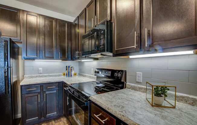 a kitchen with dark wood cabinets and white countertops