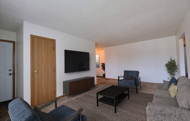 Living room filled with furniture and a flat screen tv at Parkwest Gardens West ND 58078 