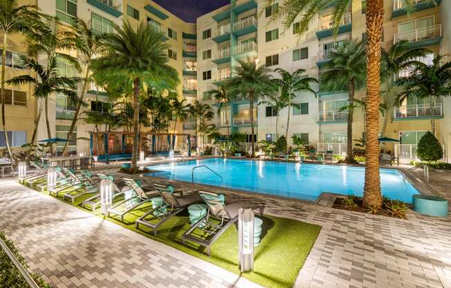 a swimming pool at a resort with palm trees