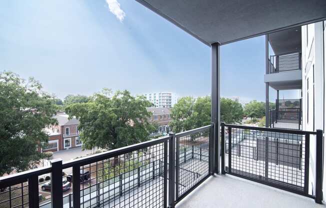 a balcony with a view of trees and a city