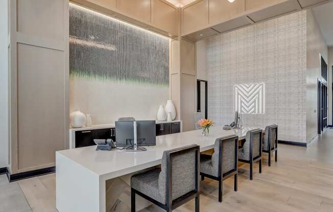 a modern office with a long desk and chairs