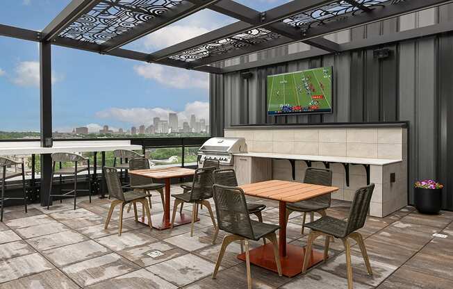 A patio with a table and chairs and a TV showing a soccer game.