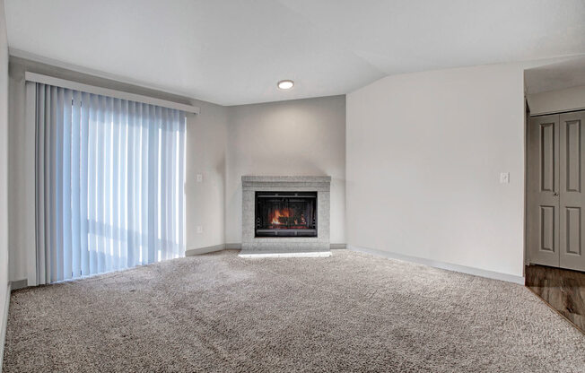 a living room with a fireplace and a window