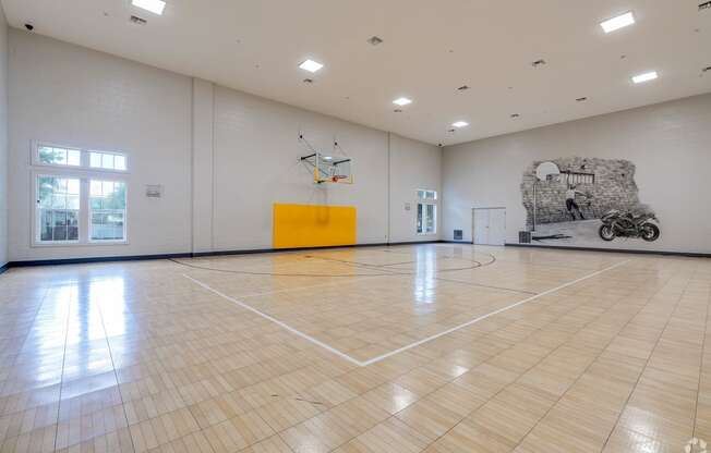 a basketball court in the center of a large room