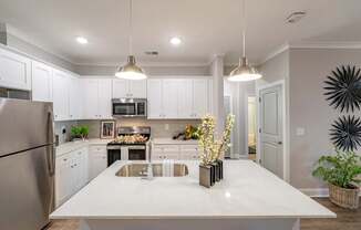 A modern kitchen with a large island in the center. at The One at Spartanburg, Spartanburg