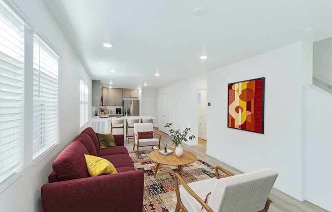 a living room with a red couch and a table