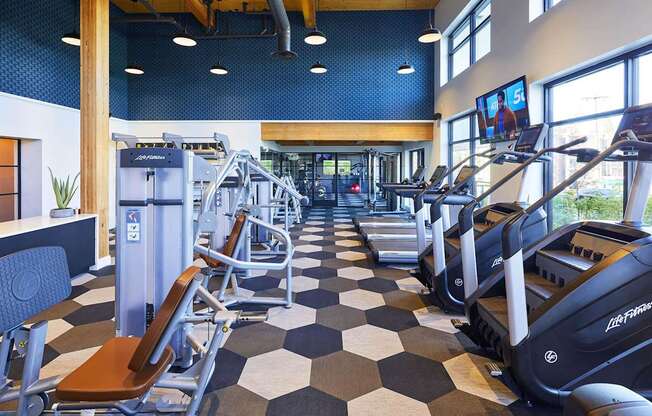 A gym with treadmills and exercise equipment.at Postmark Apartments, Shoreline