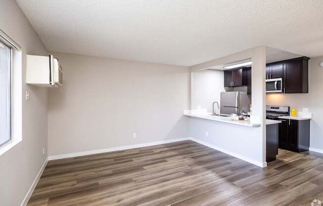 A kitchen area with a refrigerator, microwave, and oven.