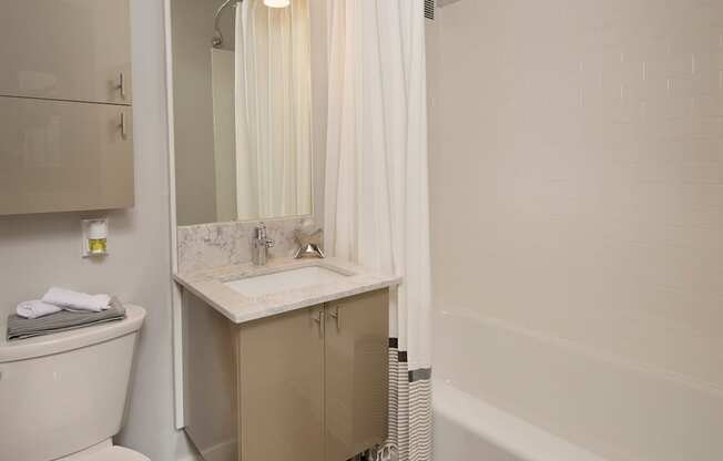 A white toilet sits next to a sink in a bathroom.
