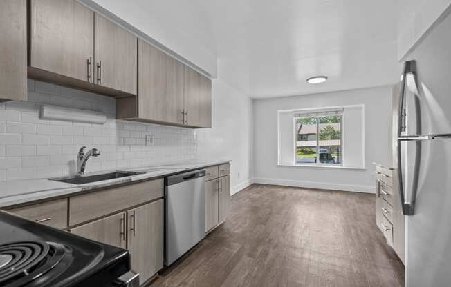 an empty kitchen with wood flooring and stainless steel appliances at Edge At Farmington Hills - Farmington Hills, MI, Michigan