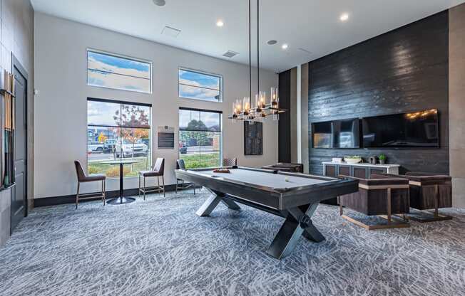 a game room with a pool table and a tv