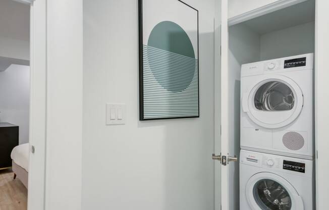 a white washer and dryer in a room with a door