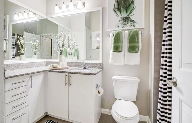 a white bathroom with a toilet and a sink