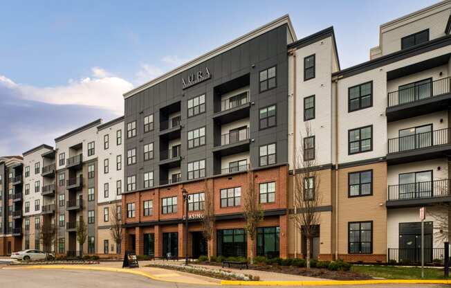 an exterior view of an apartment building on a city street at Aura Stonebridge, Richmond, VA