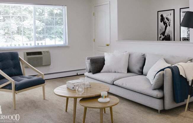 Living room set with throw pillows and blankets at Lakeside Village, East Patchogue, NY