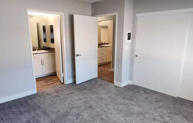 a living room with a carpet and a door to a bathroom