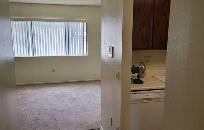 Hallway view of kitchen enterance and front room at Magnolia Apartments in Riverside, California.