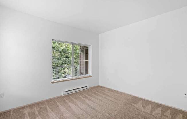 a room with a large window and white walls