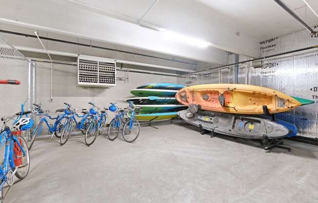 A row of bicycles are parked in a garage.