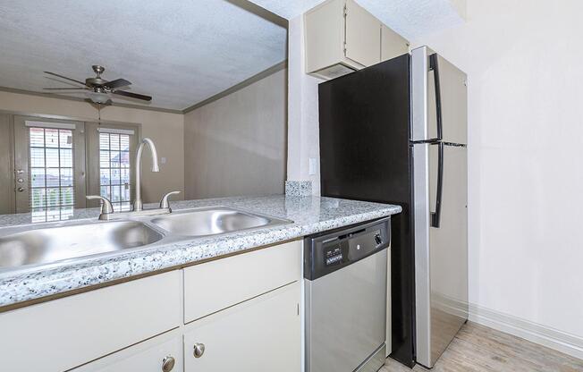 a kitchen with a sink and a mirror