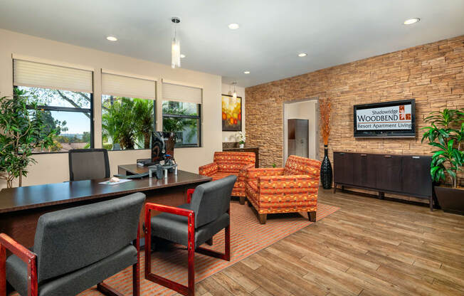 A conference room with a brick wall and a sign that says "Woodbend Residential Living".